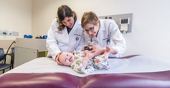 Drs. Stein and Rosenblatt examining pediatric patient
