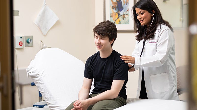 Pediatric hematologist/oncologist Ami Desai, MD, examines a patient