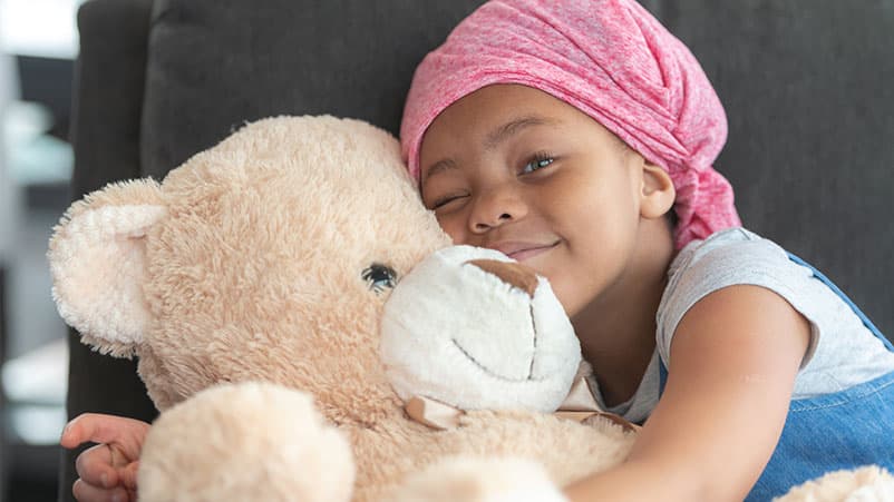 Doctor sitting on cabinet looking right, looking happy