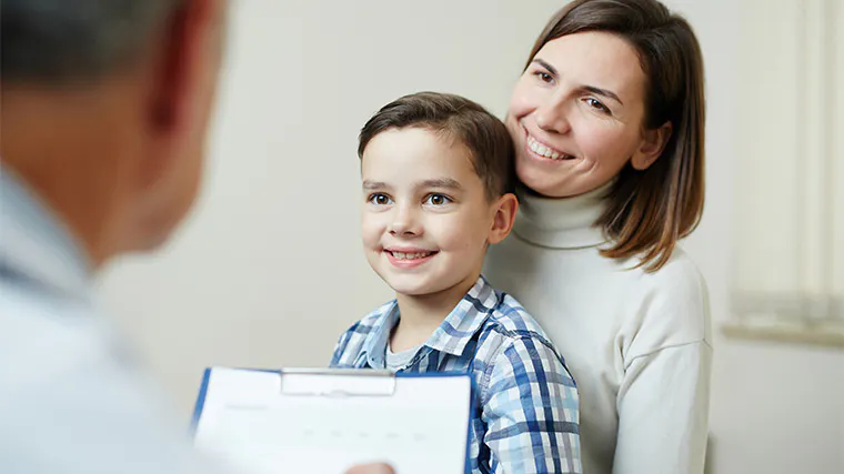 woman and  son looking at doctor and listening to his recommendations