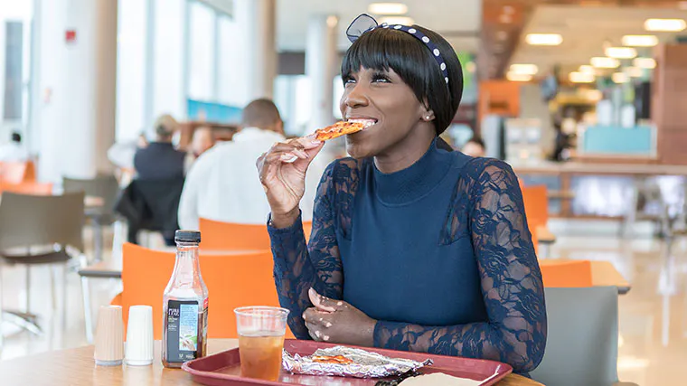 Dorian Brantley, University of Chicago patient and UChicago Medicine nurse, eating pizza again after her achalasia surgery